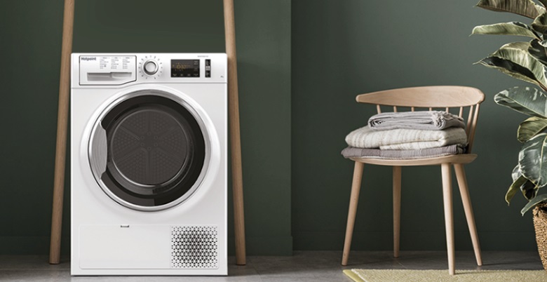 Hotpoint Tumble Dryer and neighbouring wooden chair.